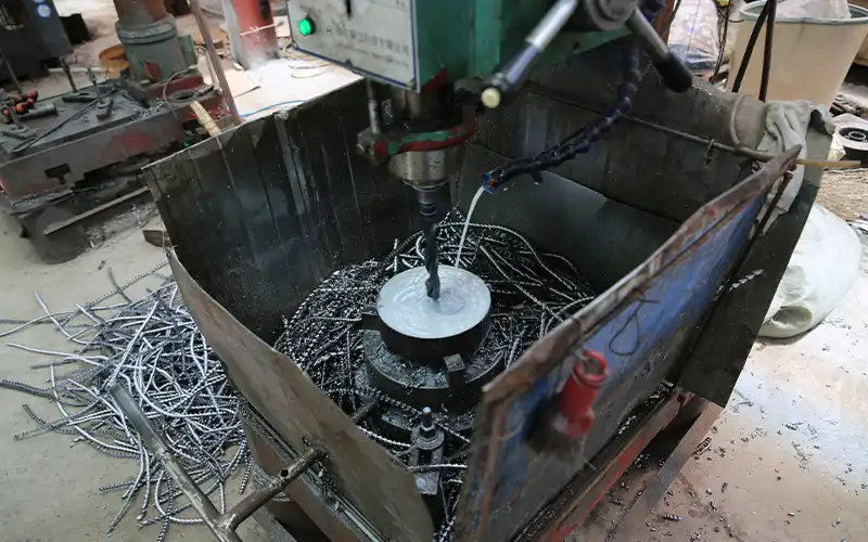 CNC drilling of barbell plate center hole at LanDer factory