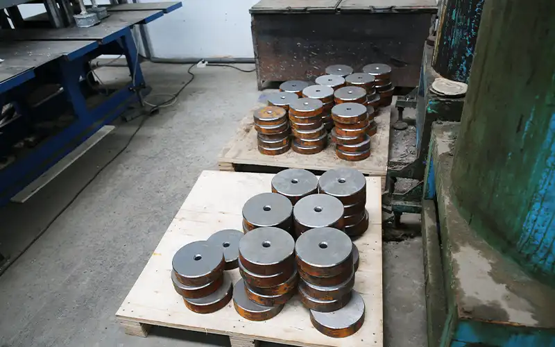 Barbell plates before coating — raw manufacturing stage showing OEM vs ODM process flexibility