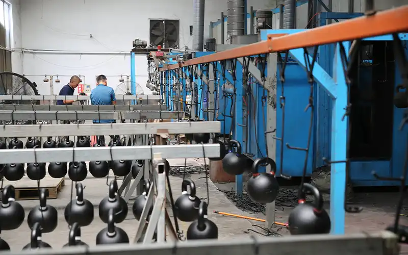 Kettlebell assembly and finishing station at LanDer factory