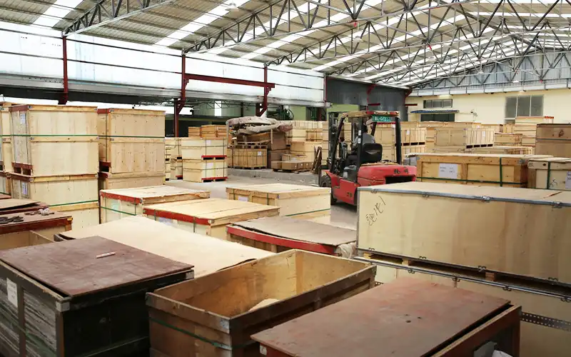 Export-ready packed barbell plates on pallets at LanDer factory